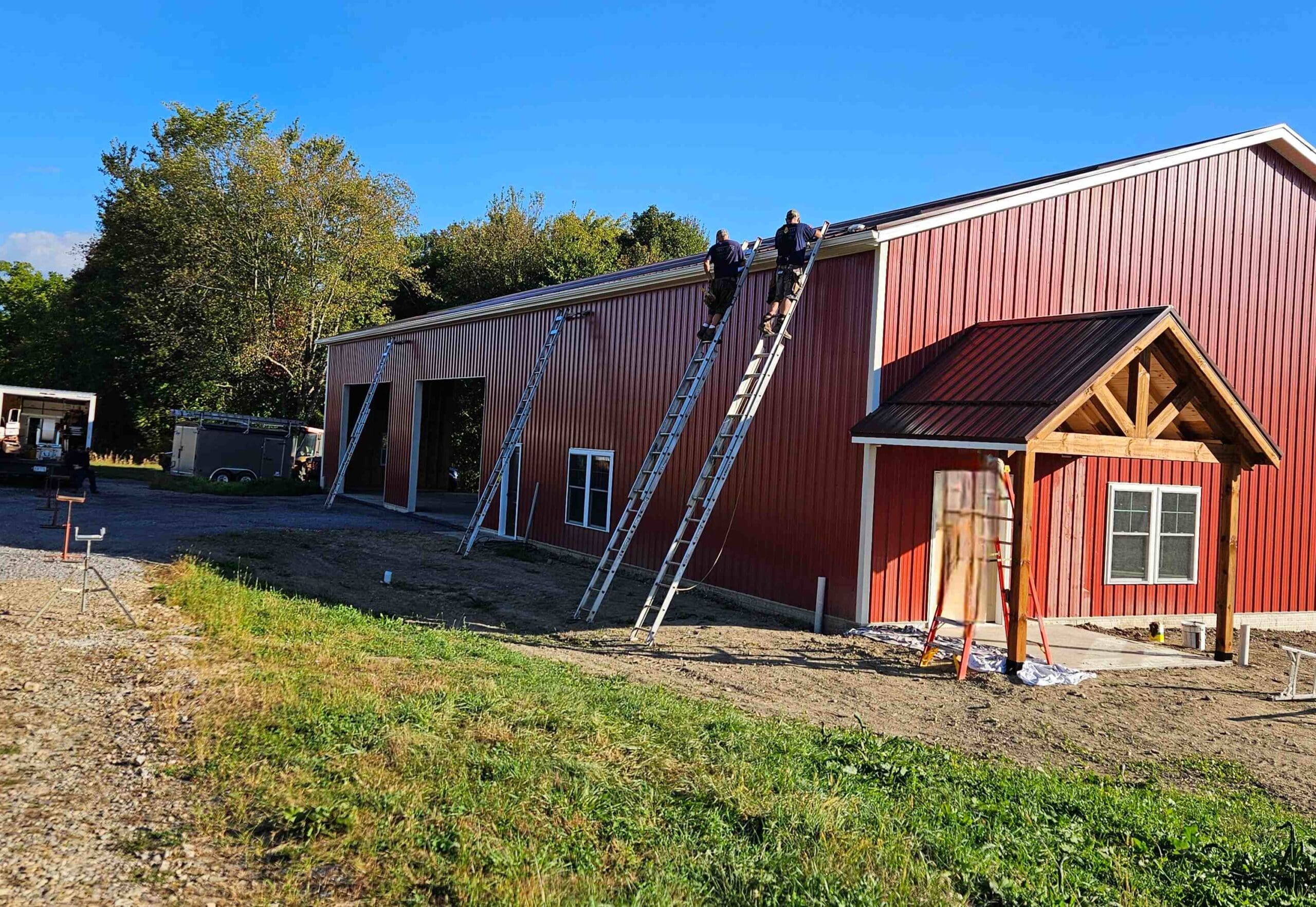 Red exterior barn during gutter installation